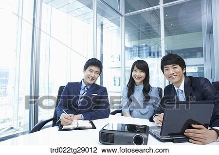 Stock Image - business people working together in office. Fotosearch
