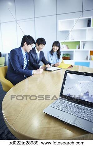 Stock Photo - business people working together in office. Fotosearch