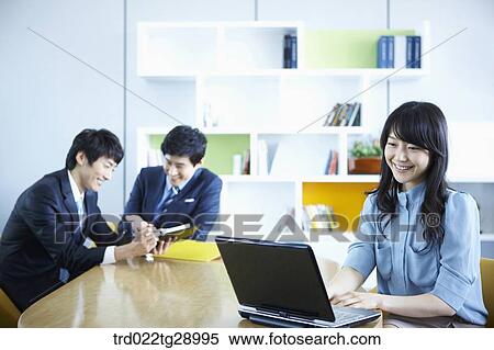 Stock Photography - business people working together in office. Fotosearch