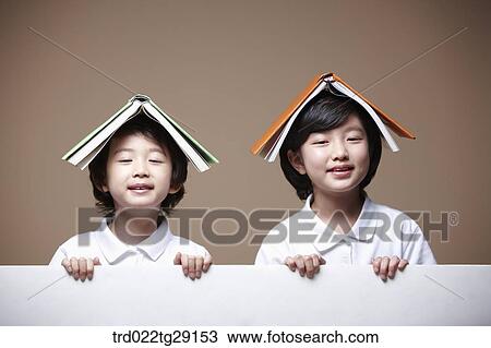 children balancing a book on their head View Large Photo Image Stock Image - children balancing a book on their head. Fotosearch