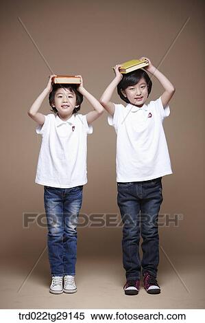 children balancing a book on their head View Large Photo Image Stock Photography - children balancing a book on their head. Fotosearch