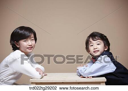 Stock Image - children facing each other. Fotosearch