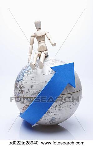 Stock Image - doll sitting on globe. Fotosearch