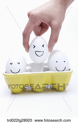 finger picks egg up View Large Photo Image Stock Photography - finger picks egg up . Fotosearch