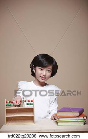 Stock Photo - girl using an abacus. Fotosearch
