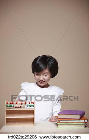 Stock Photograph - girl using an abacus. Fotosearch