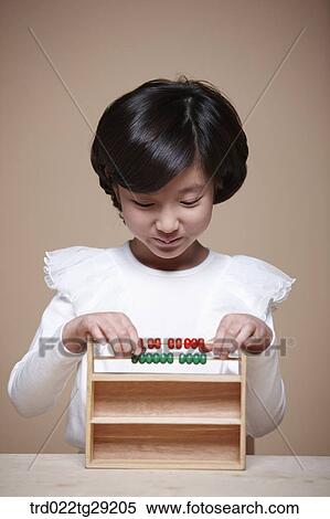 Stock Photography - girl using an abacus. Fotosearch
