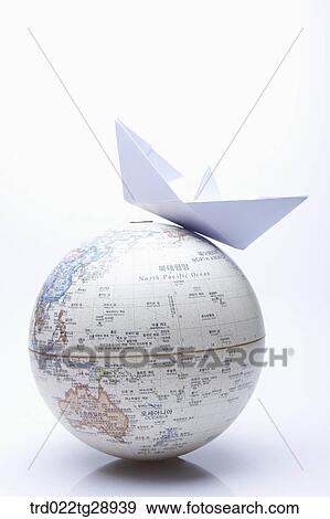 Stock Photo - paper ship on globe. Fotosearch