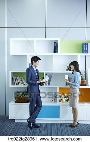 Stock Image - people have tea time together in office. Fotosearch