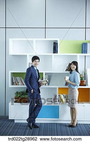Stock Image - people have tea time together in office. Fotosearch
