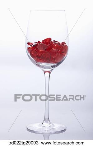 Stock Image - red buttons in wine glass. Fotosearch