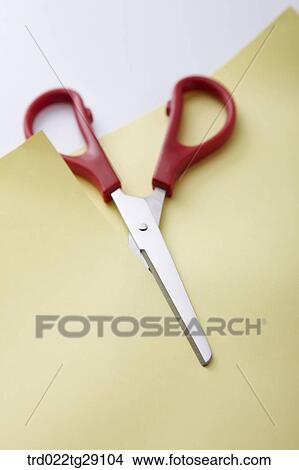 Picture - scissors cutting paper. Fotosearch