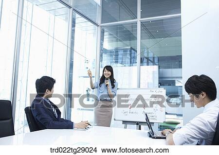 woman doing presentation to people in meeting room View Large Photo Image Picture - woman doing presentation to people in meeting room. Fotosearch