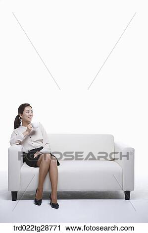Stock Image - woman has tea time. Fotosearch