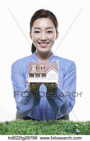 Stock Photo - woman picking miniature. Fotosearch