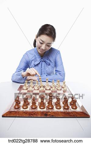 Stock Photo - woman playing chess. Fotosearch