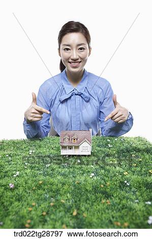 woman pointing at miniature View Large Photo Image Stock Photo - woman pointing at miniature. Fotosearch