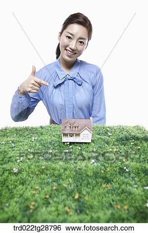 woman pointing at miniature View Large Photo Image Stock Photograph - woman pointing at miniature. Fotosearch