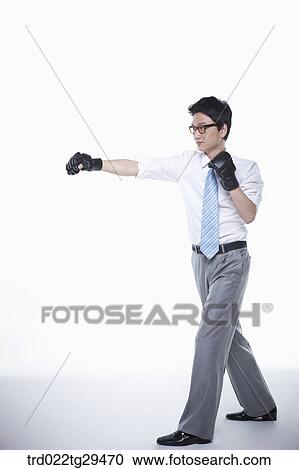 Stock Image - business man outstretched his arms wearing gloves. Fotosearch