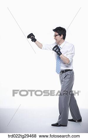 Stock Photo - business man outstretched his arms wearing gloves. Fotosearch