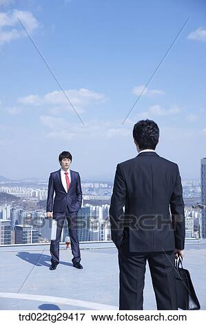 Stock Photo - business rivals directly facing each other. Fotosearch