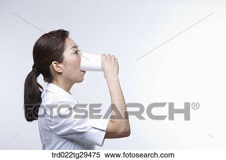 Stock Photography - business woman is drinking something. Fotosearch