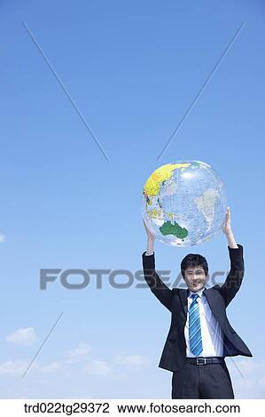businessman raises the globe View Large Photo Image Stock Image - businessman raises the globe. Fotosearch