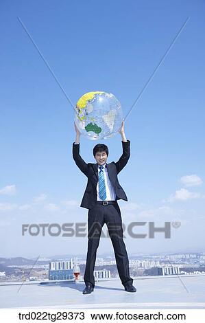 businessman raises the globe View Large Photo Image Stock Image - businessman raises the globe. Fotosearch