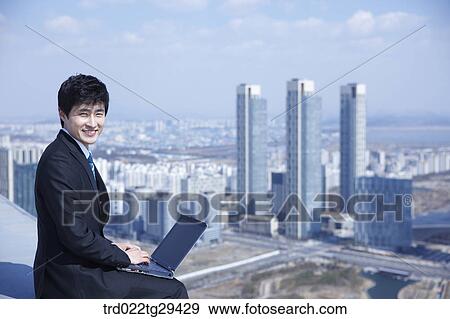 Stock Photo - businessman works using his laptop. Fotosearch