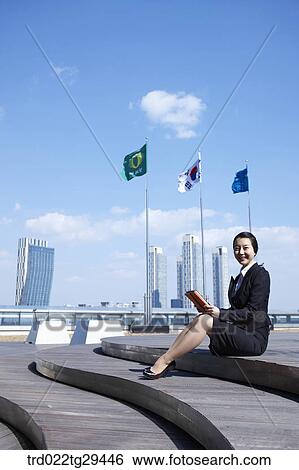 Stock Photograph - businesswoman working sitting on the stairs . Fotosearch