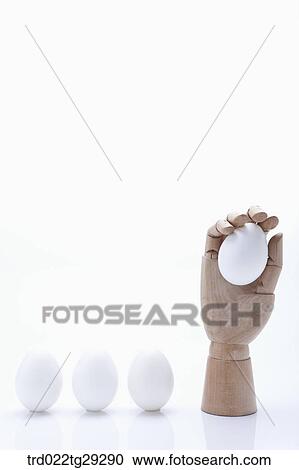 Stock Image - egg in hand. Fotosearch