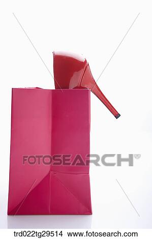 Picture - red high heels in red shopping bag. Fotosearch