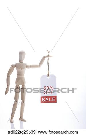Stock Photo - wooden doll holding sale tags. Fotosearch