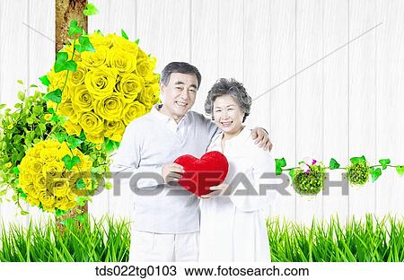 Drawing - senior couple holding heart cushion. Fotosearch