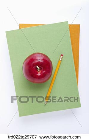 Stock Photo - apple and pencil are on the book. Fotosearch