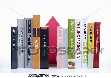 Stock Photograph - arrow sign is behind the books. Fotosearch