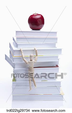 figurine going up the book View Large Photo Image Picture - figurine going up the book. Fotosearch