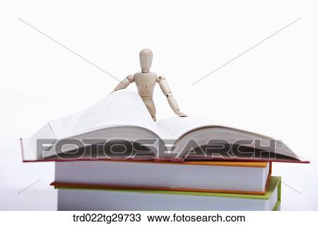 figurine reading book View Large Photo Image Stock Image - figurine reading book. Fotosearch