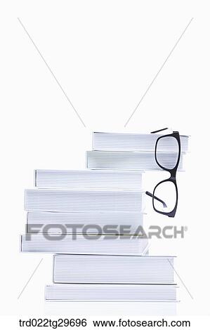 glasses hanging the piled books View Large Photo Image Stock Photograph - glasses hanging the piled books. Fotosearch