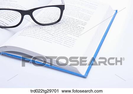 glasses on the opened book View Large Photo Image Stock Image - glasses on the opened book. Fotosearch