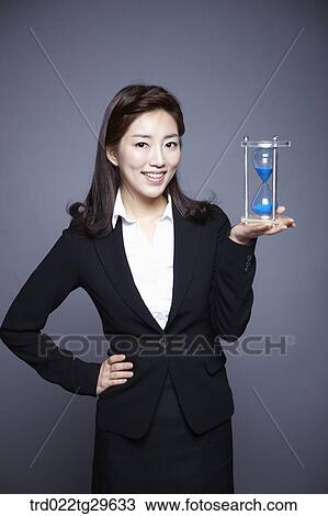 hourglass on woman's hand View Large Photo Image Stock Image - hourglass on woman's hand. Fotosearch
