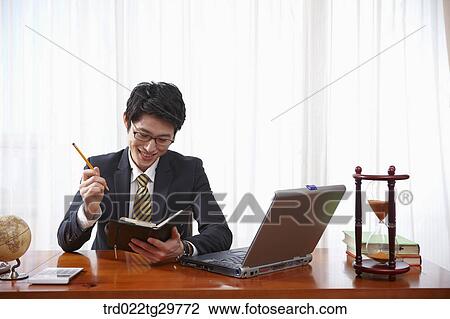 man checks his schedule through schedule book View Large Photo Image Stock Image - man checks his schedule through schedule book. Fotosearch