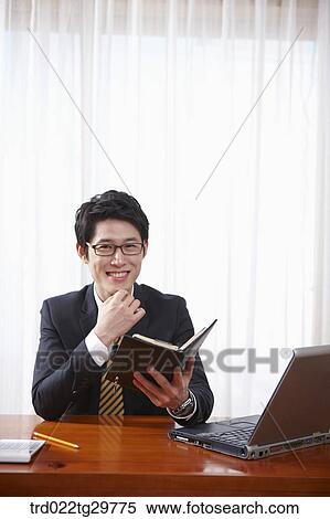 man checks his schedule through schedule book View Large Photo Image Stock Photography - man checks his schedule through schedule book. Fotosearch