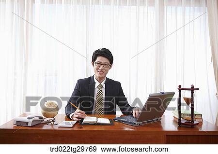 man doing his work on the desk View Large Photo Image Stock Photo - man doing his work on the desk. Fotosearch