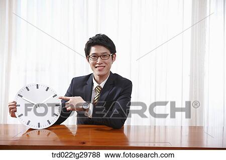 man holding clock View Large Photo Image Stock Photo - man holding clock. Fotosearch