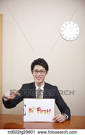 Stock Image - man holding message board. Fotosearch