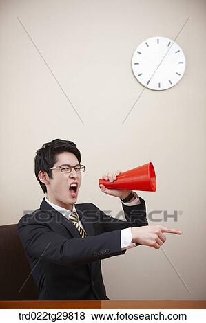 Stock Photo - man is yelling with loud speaker. Fotosearch