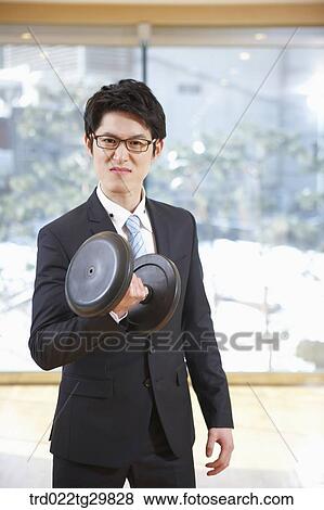 Stock Photo - man lifts dumbbell. Fotosearch