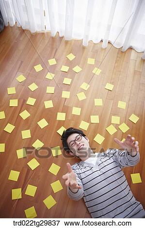 man stretched his arms out lying on the floor View Large Photo Image Stock Photo - man stretched his arms out lying on the floor. Fotosearch