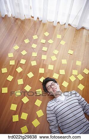 man stretched his arms out lying on the floor View Large Photo Image Stock Photo - man stretched his arms out lying on the floor. Fotosearch